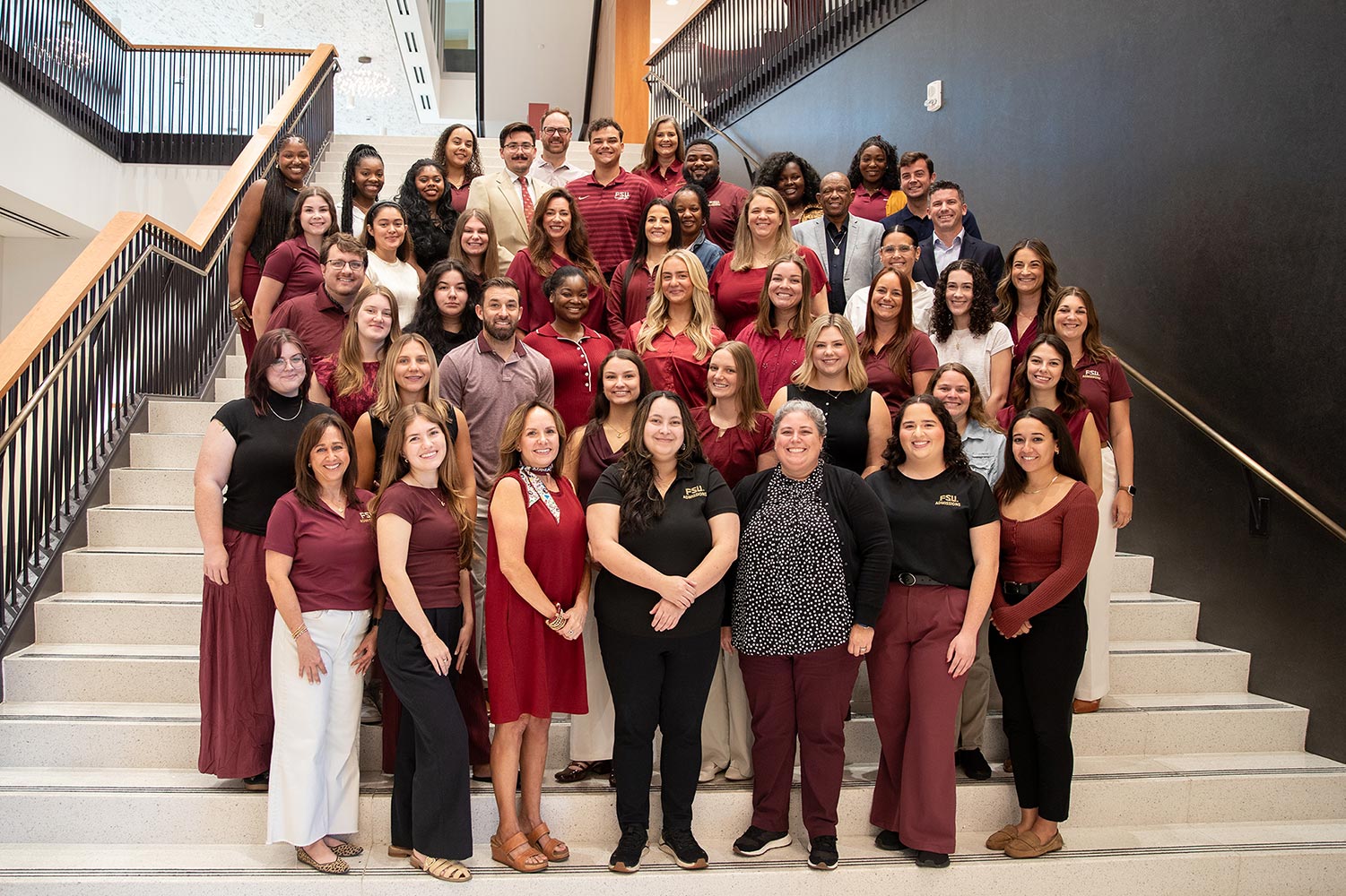 Admissions staff at FSU. Admissions staff in front of the Three Torches Fountain at FSU.